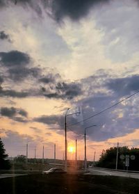 Street against sky during sunset