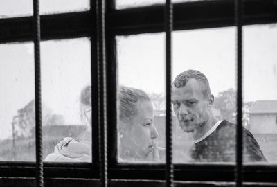 Man and woman seen through window