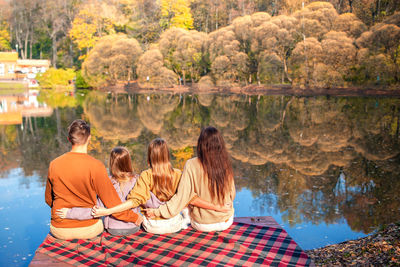Family sitting by lake