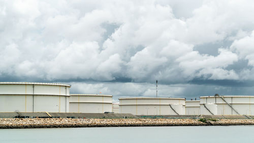 View of factory against cloudy sky