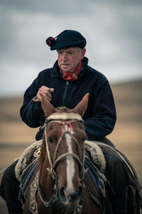 Mid adult man riding horse