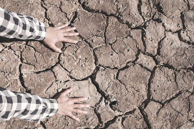 High angle view of man standing on cracked land