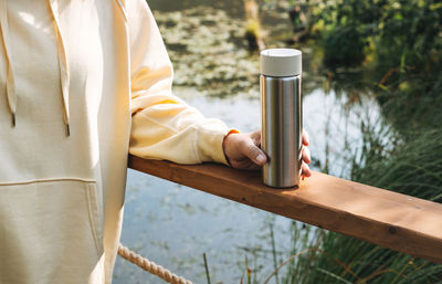 Midsection of woman holding coffee