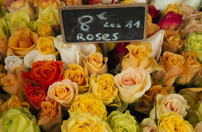 High angle view of price tag amidst rose bouquet