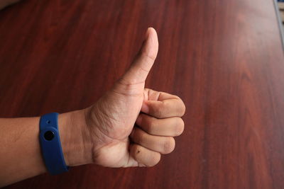 Close-up of person hand on wood