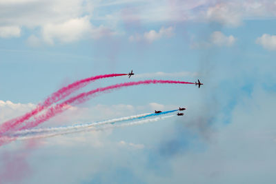 Low angle view of airshow in sky