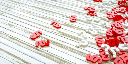 High angle view of text on red toy over white background