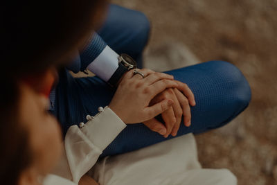 Midsection of couple holding hands