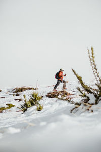 Full length of man walking on snow covered land