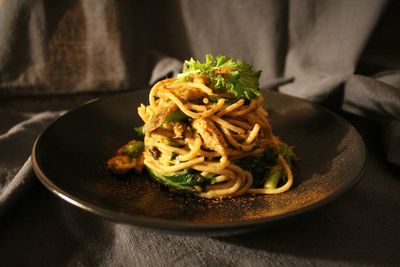 Close-up of cooked spaghetti served in plate on table