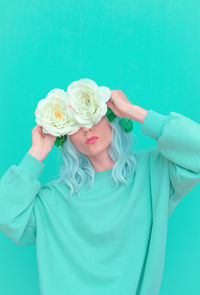 Portrait of woman holding blue flower