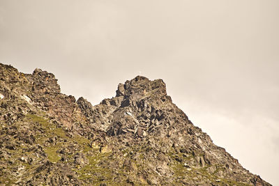 Low angle view of rock formation against sky