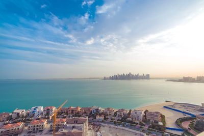 Panoramic view of buildings and sea against sky