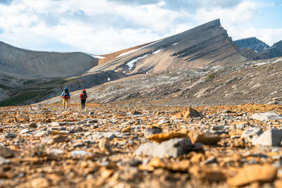 Couple hiking remote unnamed pass near banff national park