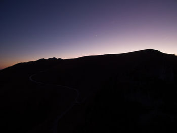 Scenic view of silhouette mountain against sky at sunset