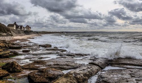 Scenic view of sea against cloudy sky