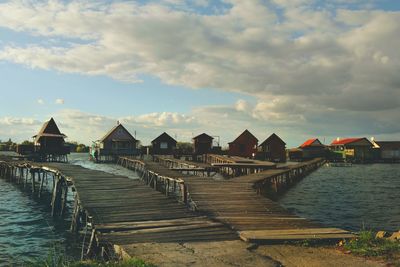 View of jetty in sea against cloudy sky