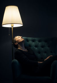 Portrait of a woman with a floor lamp