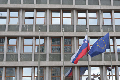 Low angle view of flags against building