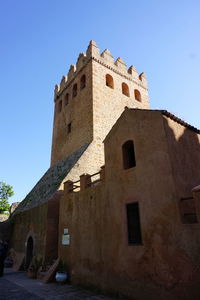 Low angle view of historical building against blue sky