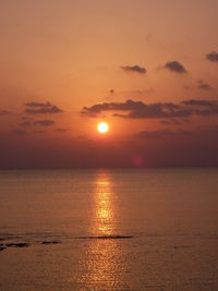 Scenic view of calm sea at sunset