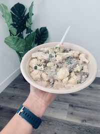 High angle view of hand holding ice cream in bowl