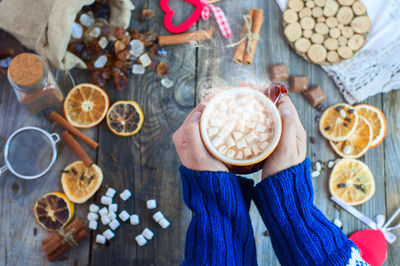 High angle view of person holding hot chocolate