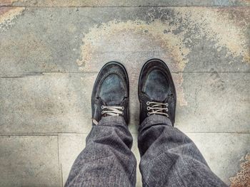 Low section of man standing on footpath