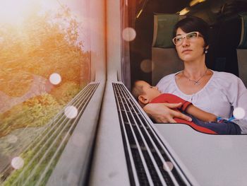 Portrait of woman sitting on train