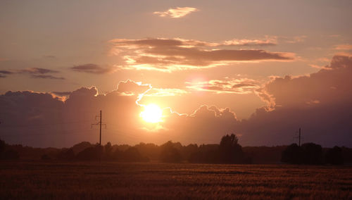 Scenic view of field against sky during sunset