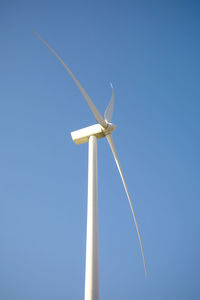 Wind turbine on field against sky