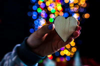 Close-up of hand holding multi colored lights