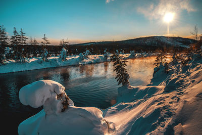 Scenic view of frozen lake against sky during winter