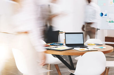 Midsection of businessman using digital tablet in office