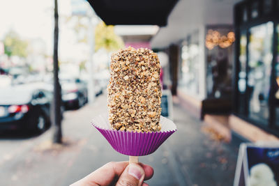 Close-up of hand holding ice cream cone