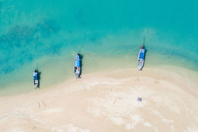 Three long tail boat on the beach in thailand aerial view