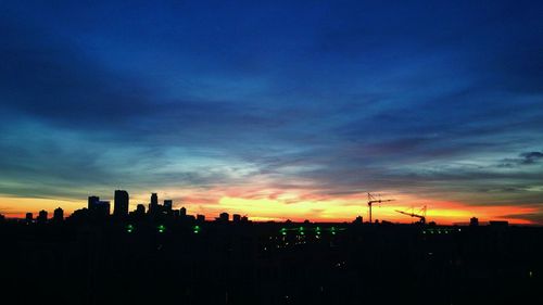 Silhouette of building against dramatic sky