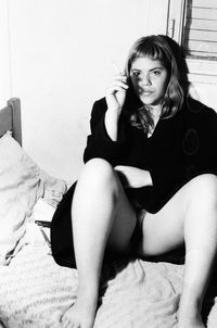 Portrait of beautiful young woman using smart phone at home