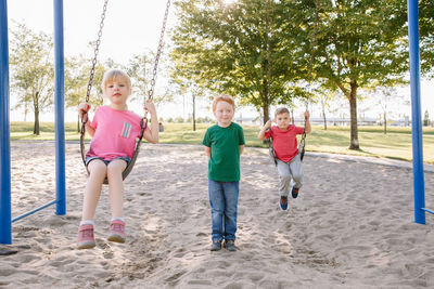 Children swinging at playground