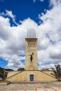 Low angle view of historical building against cloudy sky