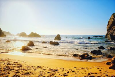 Scenic view of beach against clear sky