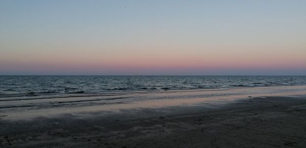 Scenic view of sea against clear sky during sunset