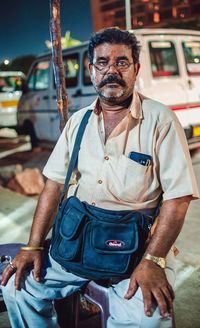 Portrait of man standing by car