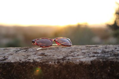 Close-up of sunglasses on rock