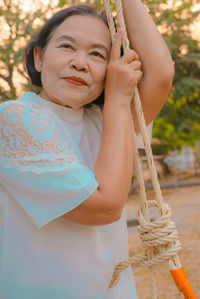 Portrait of smiling woman holding camera