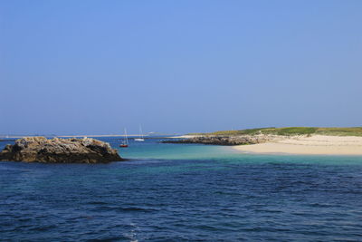 Scenic view of sea against clear blue sky