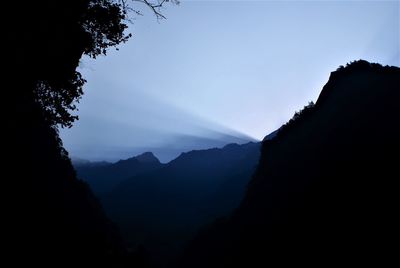 Scenic view of silhouette mountains against sky at dusk