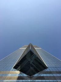 Low angle view of modern building against blue sky