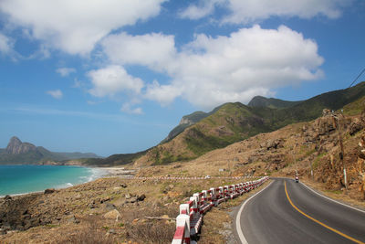 Road by sea against sky