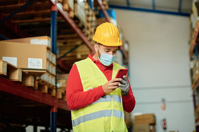 Rear view of man standing in factory